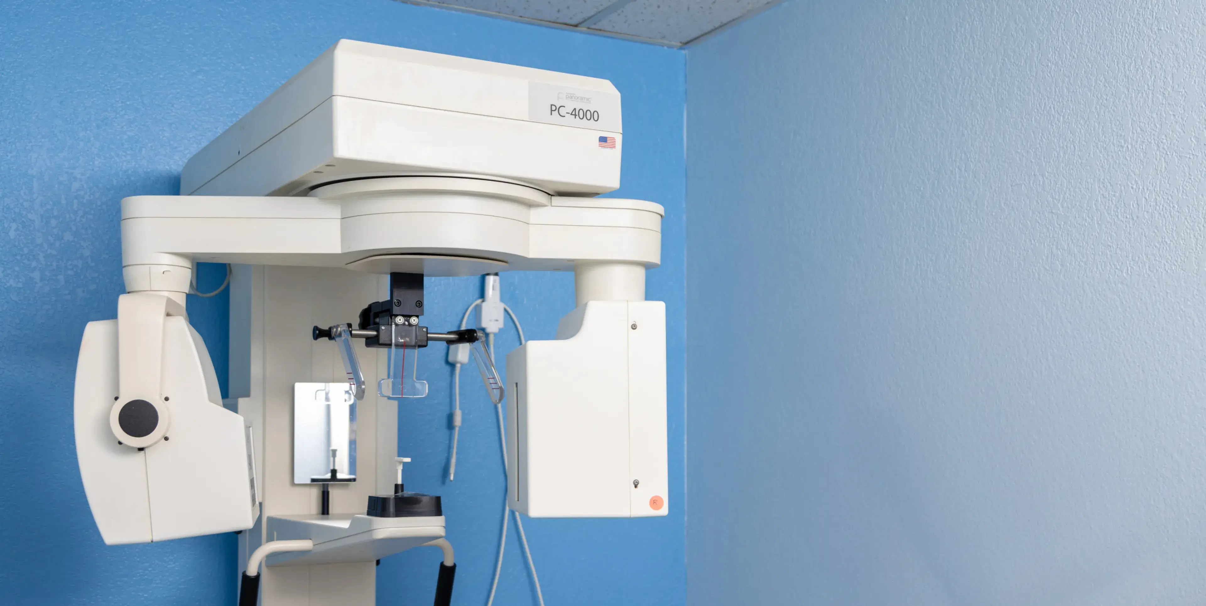 A medical device mounted to a wall in a room.